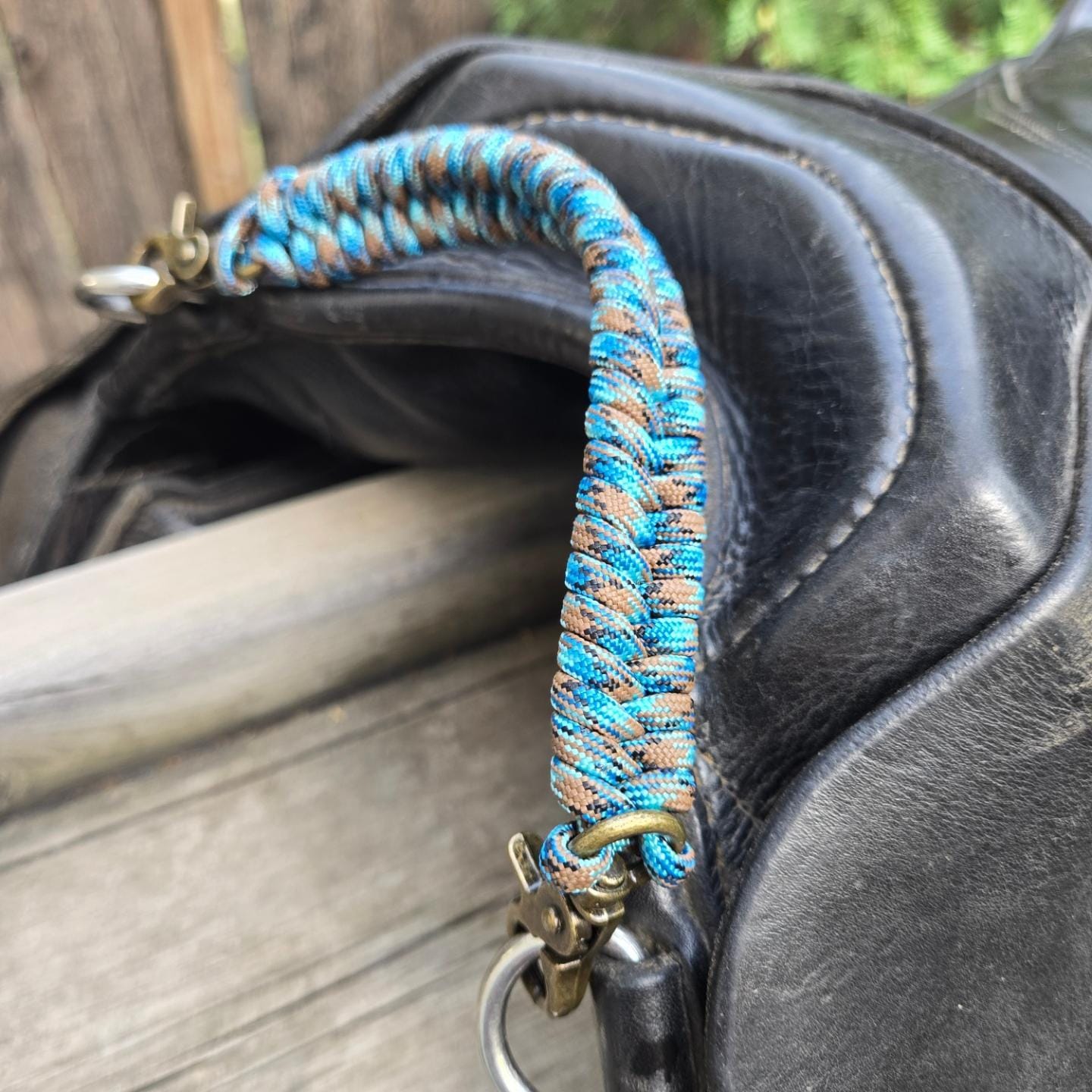 Abyss blue/ orange, brown, grey paracord grab strap, cusstom length attached to black saddle