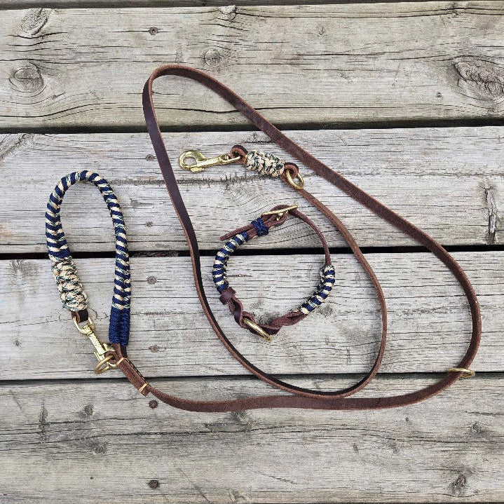 Brown leather dog leash with decorative elements on a wooden surface